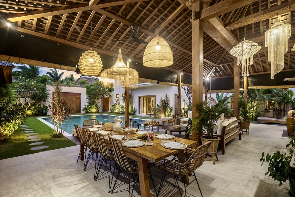 Illuminated dining area with a pool view 