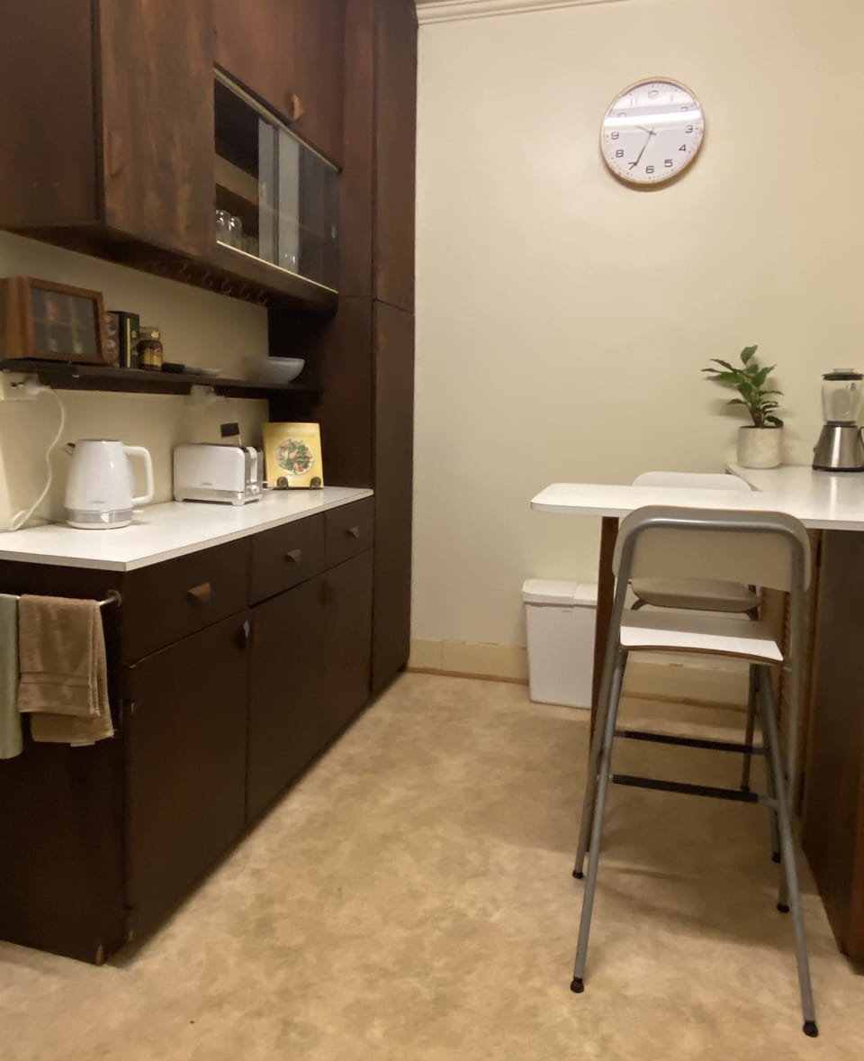 Kitchen - bench & stools, kettle, toaster, microwave & cooking utensils.