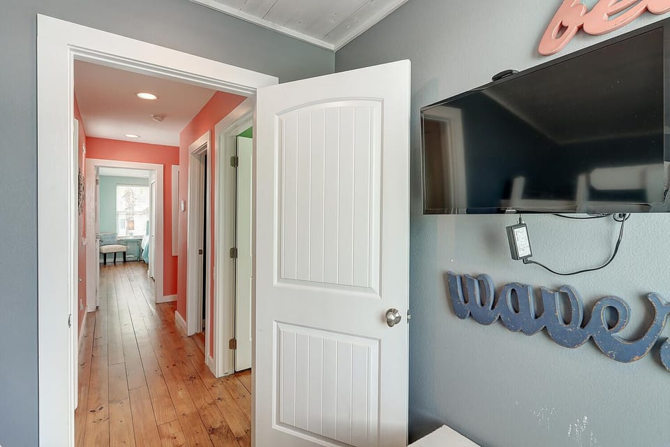 Interior - From bunk room with mounted TV, looking into hallway