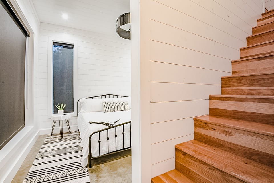There are two separate staircases on both sides of the cabin that lead to the upper level bunk rooms (bedrooms 3 and 4).