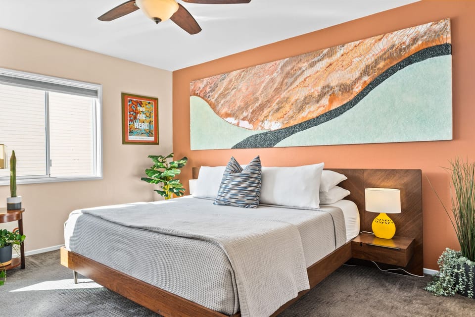 Main bedroom includes a king-sized bed and oversized artwork from a local artist
