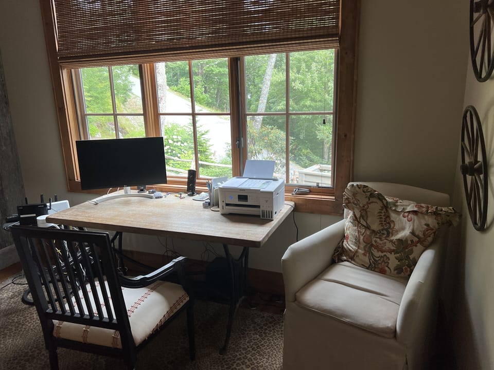 desk equipped with printer and 2 monitors