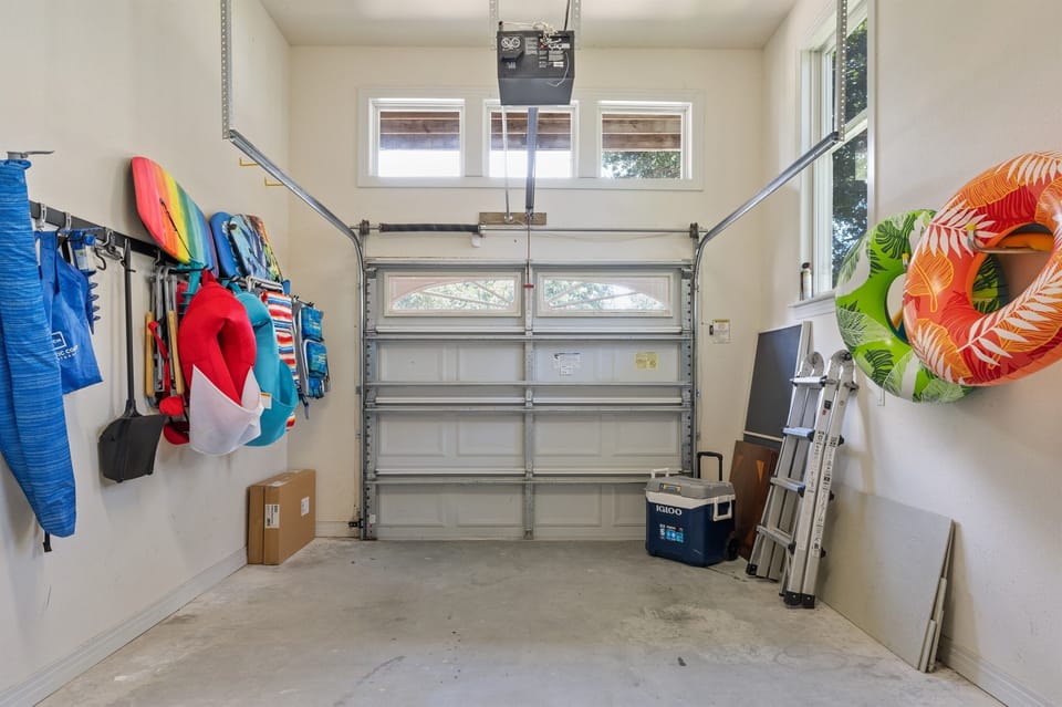 Garage space holds beach chairs, beach umbrella, boogie boards, and pool floats.