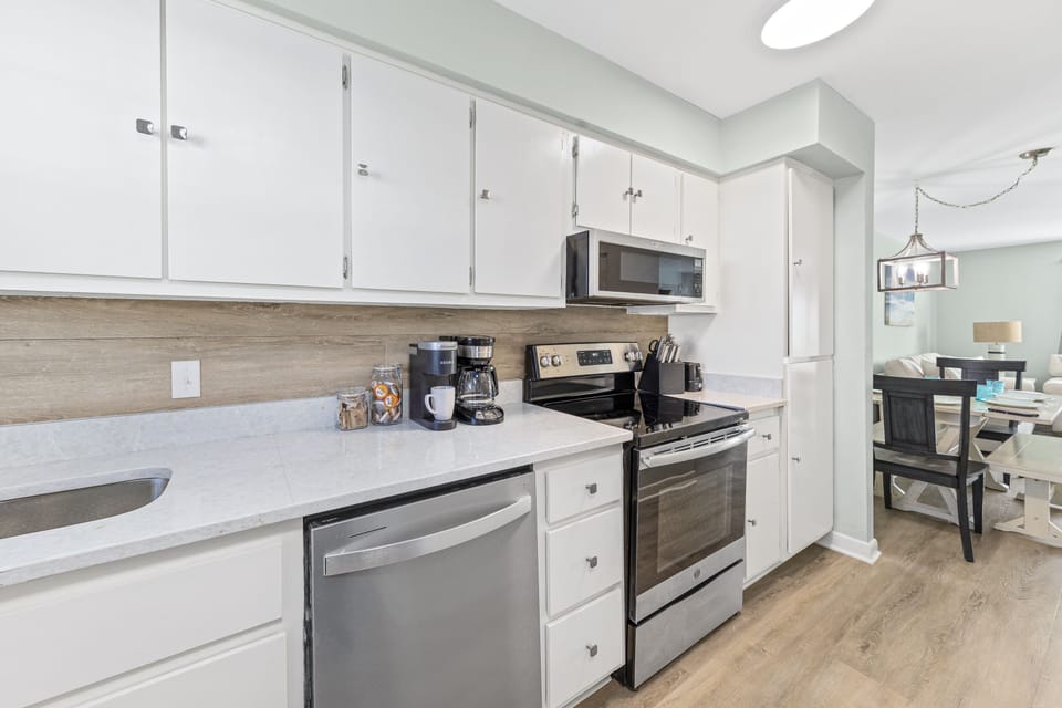 Stocked kitchen opens to the dining area.