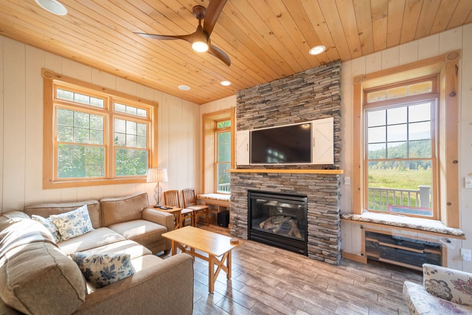 The living room features a large gas fireplace and a Smart TV.