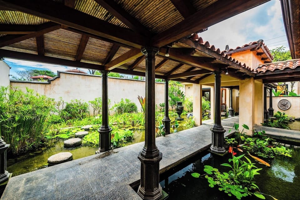 Experience the blend of nature and design with this outdoor corridor, highlighted by tranquil Koi ponds and sophisticated architecture, perfect for a stylish Costa Rica vacation rental.