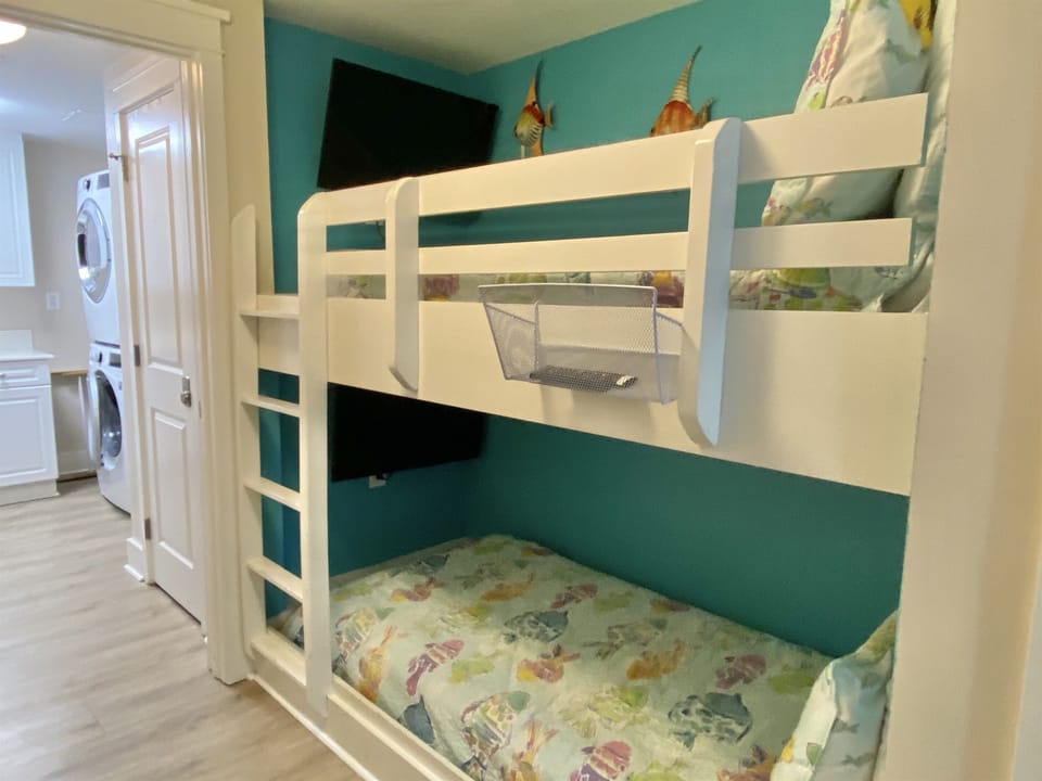 Bunk Bed nook with twin bunk beds and a TV mounted on each bunk wall.