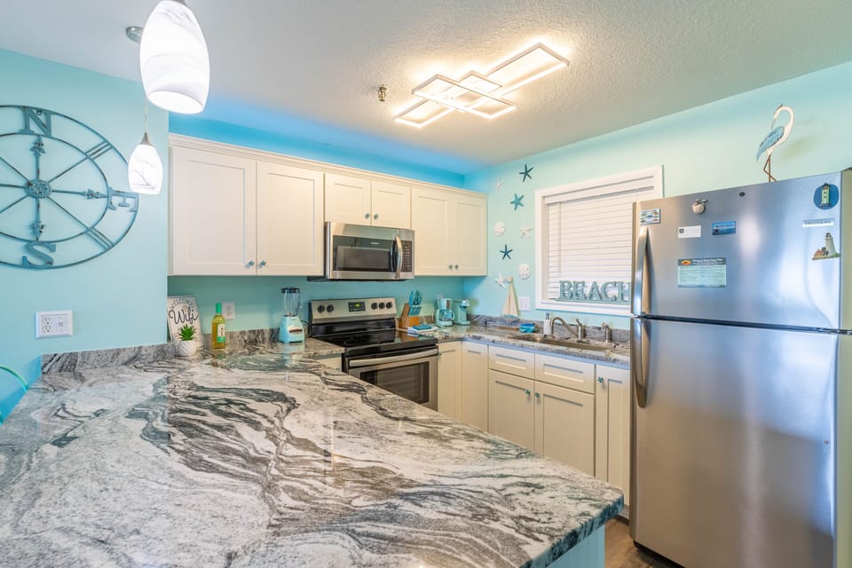 Fully equipped kitchen, with large granite counter top.