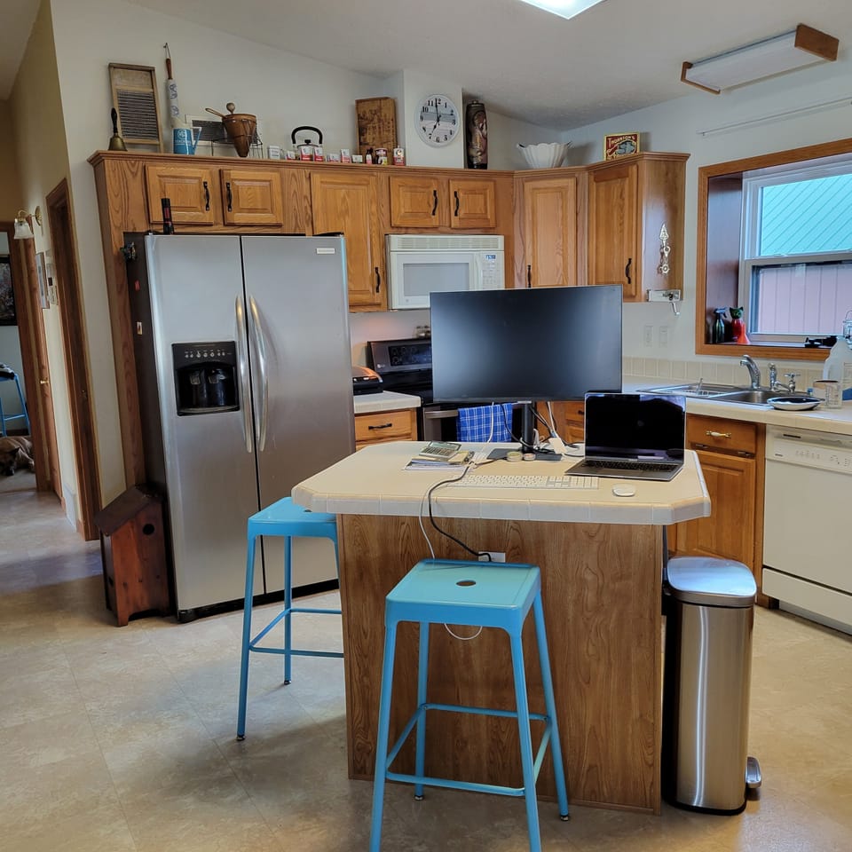 Kitchen shown with work-remote setup.