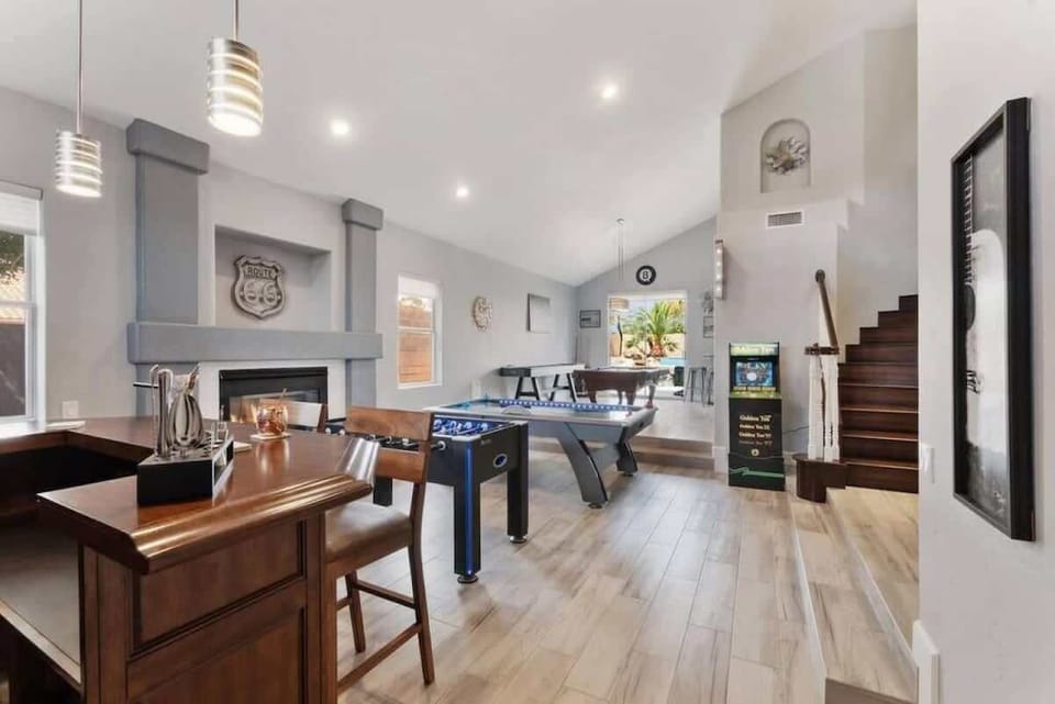Your perfect entertainment retreat features foosball, air hockey, and cozy seating by the fireplace for unforgettable game nights.