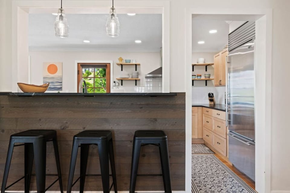 Pass-through from living room to kitchen with bar seating