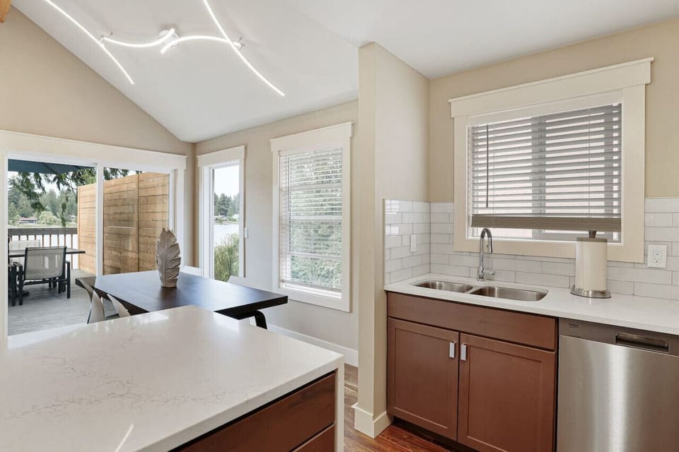 Fully stocked kitchen open into the dining room with a view of a lake.Seattle /Tacoma Area.