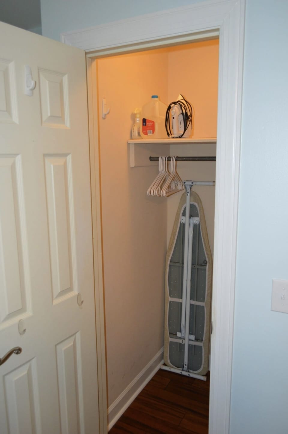 The upper level suite has 3 closets. One closet has an ironing board and iron