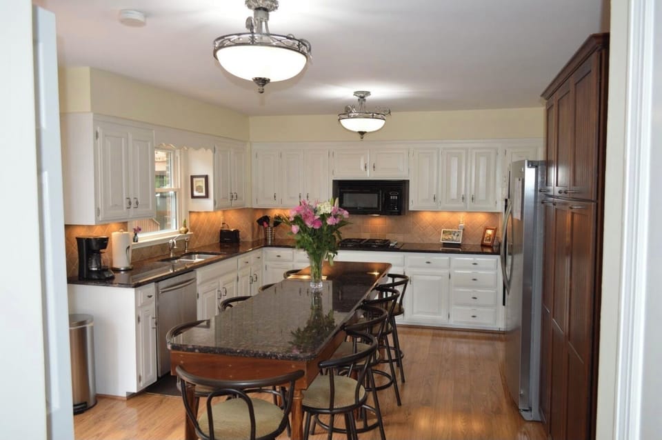 The kitchen island bar has seating for 10 with extra seating on the deck.
