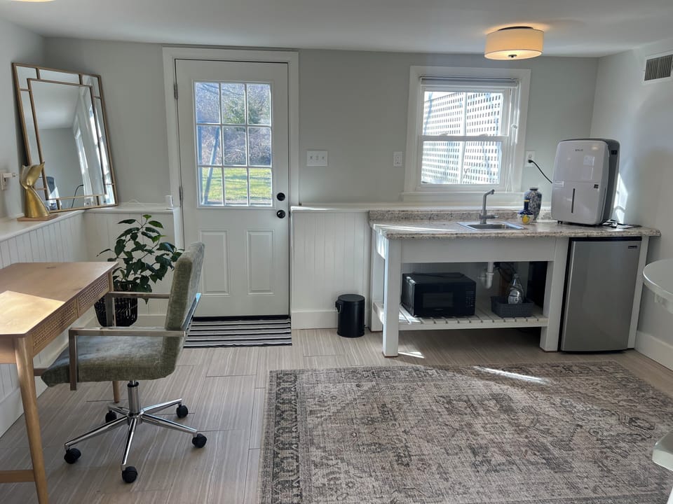 Downstairs kitchenette and office area. Microwave and mini fridge.