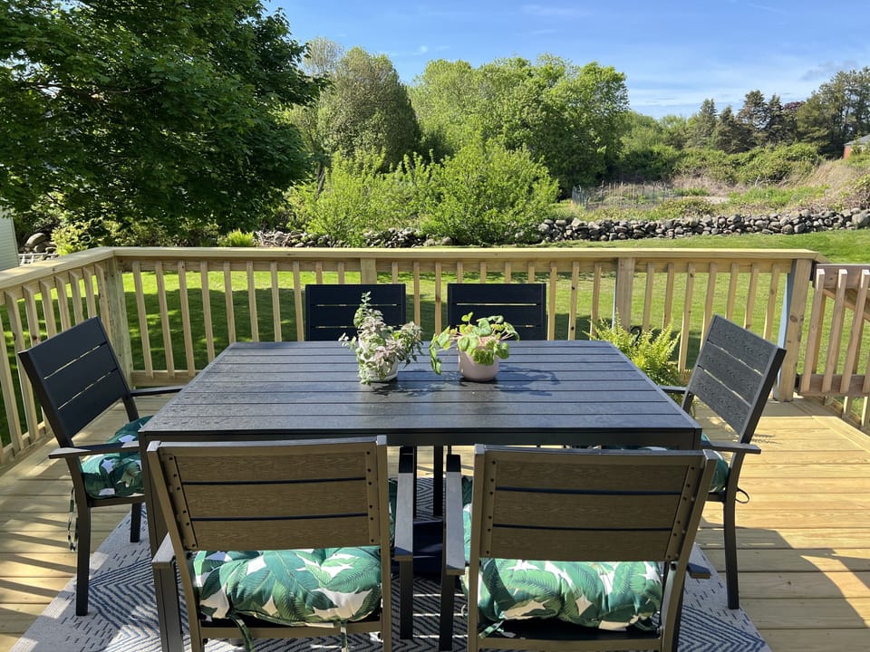 Large deck with outdoor dining and shaded lounge area Narragansett summer rental