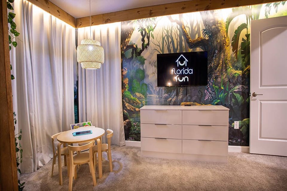 This vibrant room showcases a playful mural that invites nature inside, paired with soft, neutral tones. A stylish light fixture above a charming children's table creates a cozy corner ideal for relaxation or playtime.