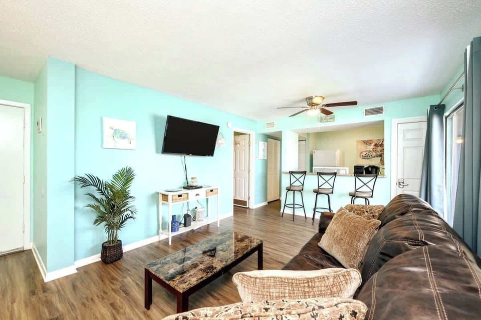 When you arrive, you'll walk right in to the living room that boasts a comfortable Queen sleeper sofa & an accent chair for lounging.