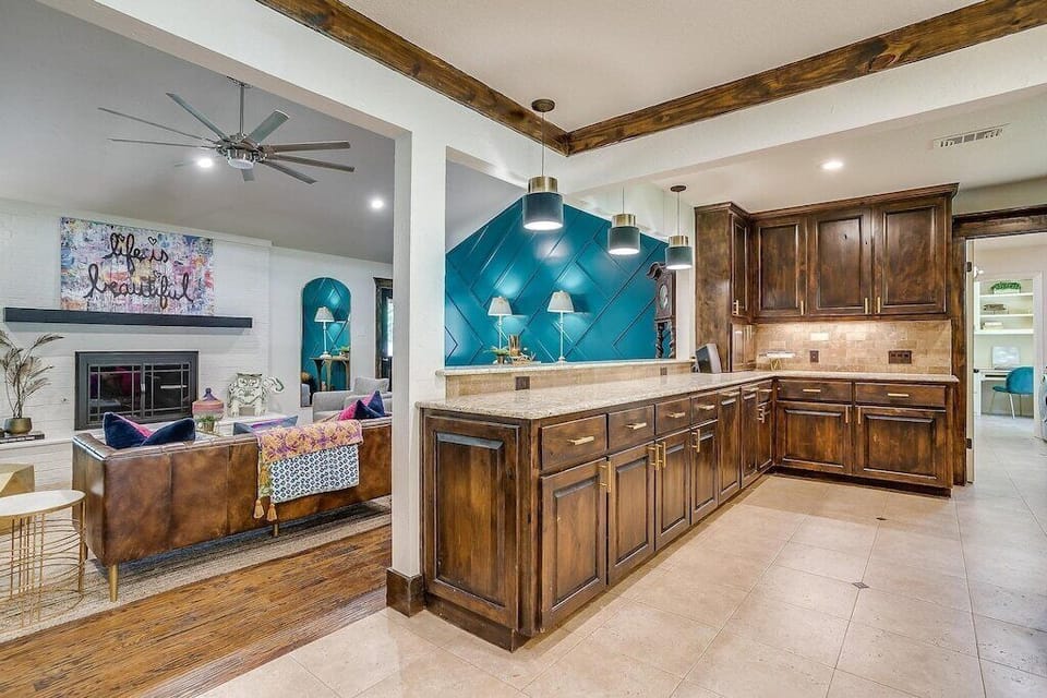 Oversized kitchen bar are overlooking great room, let’s not forget to mention the velvet green pendant lights:)