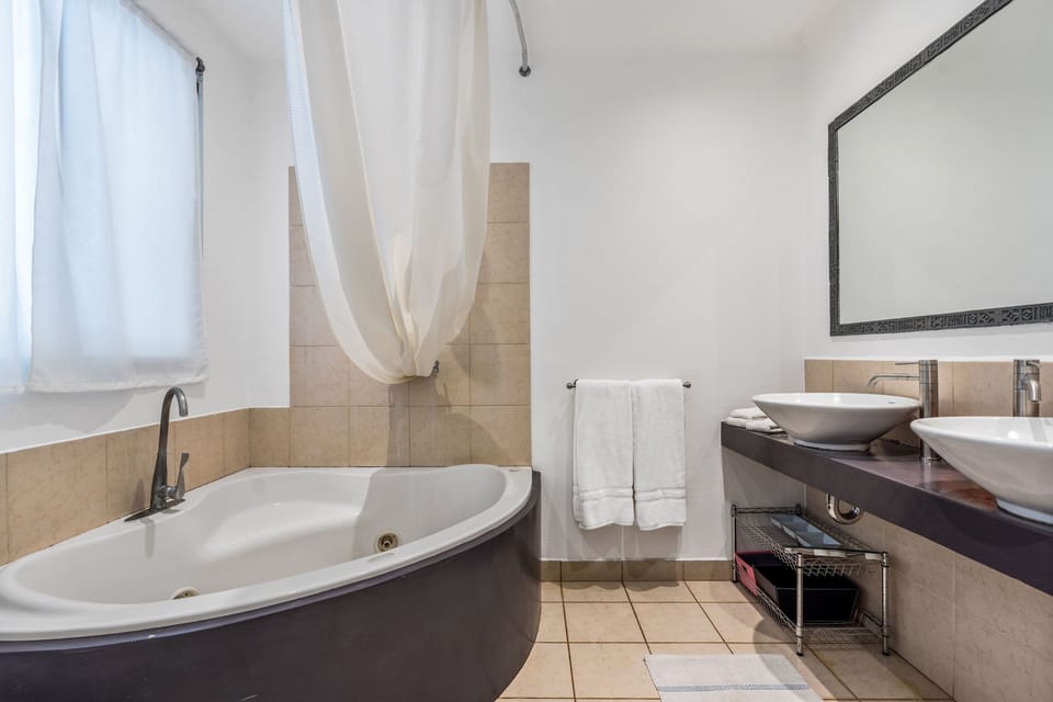 The master bedroom includes a 3 person Jacuzzi and double sinks.