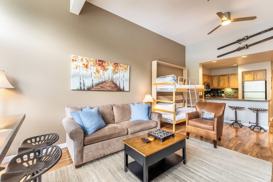 Living room area featuring vaulted ceiling, flat screen TV, gas fireplace, access to the private balcony and gorgeous views overlooking Keystone Lake.