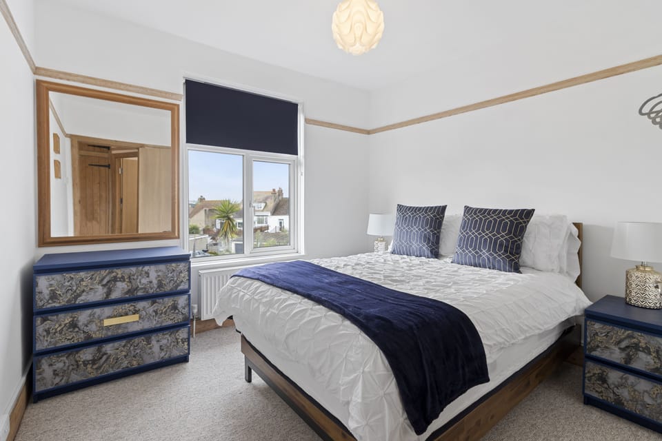 One of the first floor bedrooms containing a double bed and storage for clothes and belongings