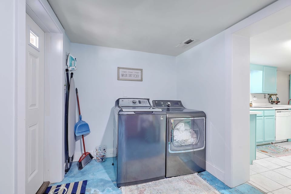 Upstairs foyer/ stairs lead down to laundry, kitchen, pool table, den,  BRs & BA