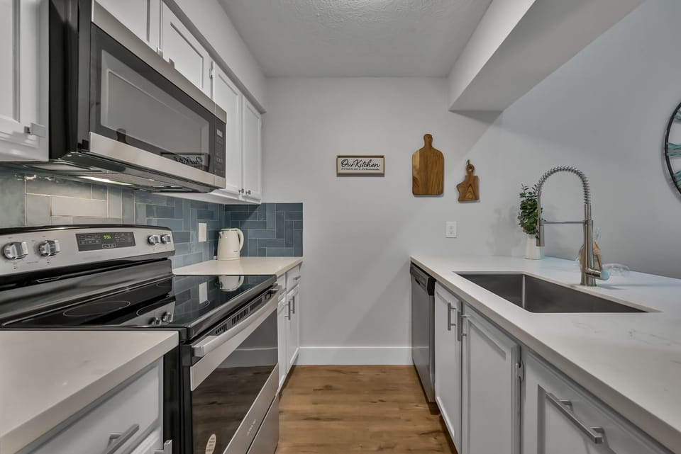 Newly remodeled kitchen with stove, microwave and dishwasher. 