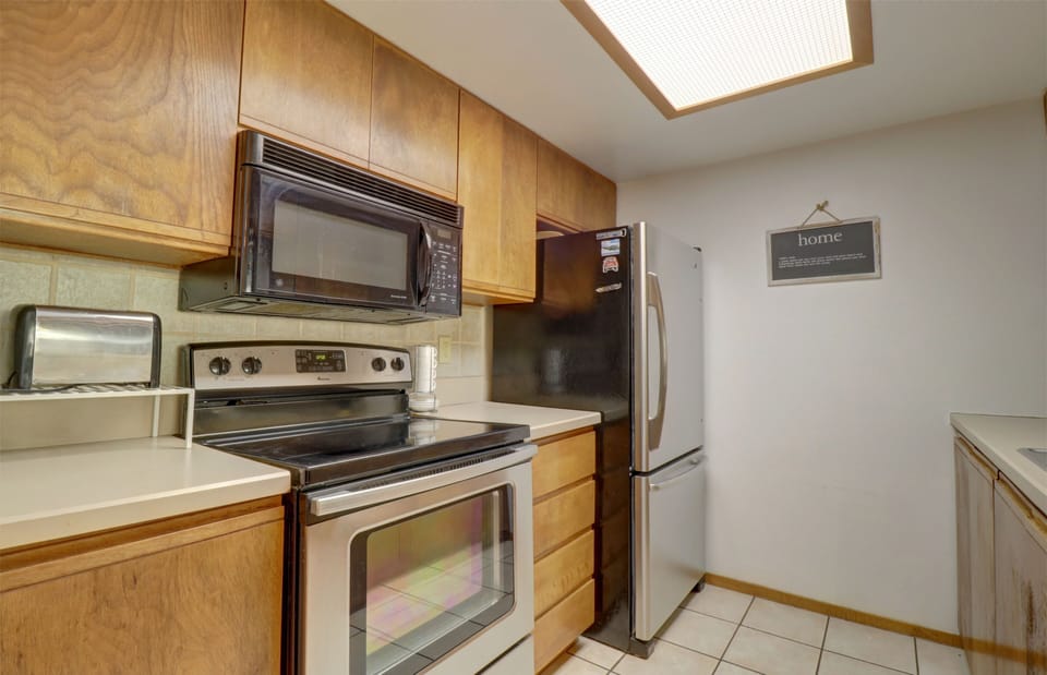 Kitchen features stainless steel appliances.