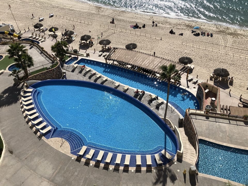 Large infinity pool with children's play pool and heated swim up bar pool
