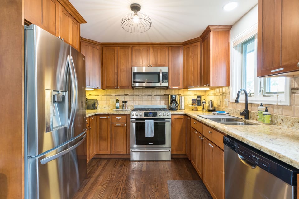 Equipped kitchen with dishes, essential appliances, coffee, and spices