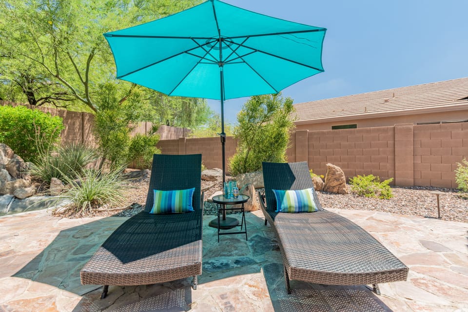 Patio sun loungers, folding table and umbrella
