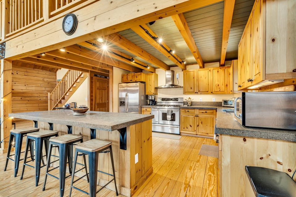 Another view of the kitchen area with island seating for 4