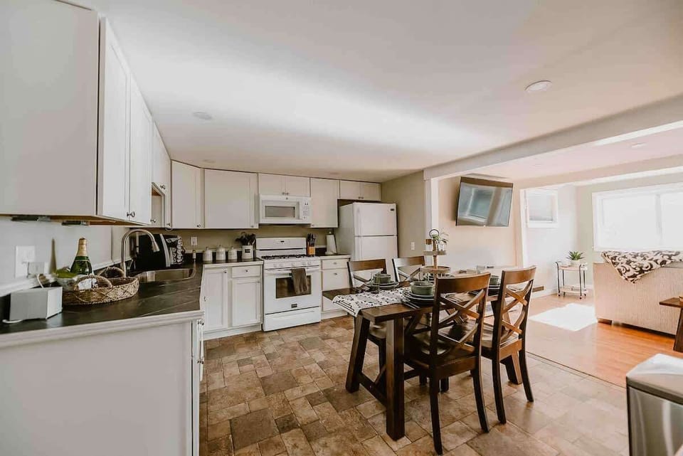 Step into the inviting kitchen and dining area, where natural light fills the space, creating a warm and open atmosphere. Perfect for enjoying meals and relaxing with loved ones, seamlessly connecting to the cozy living space.