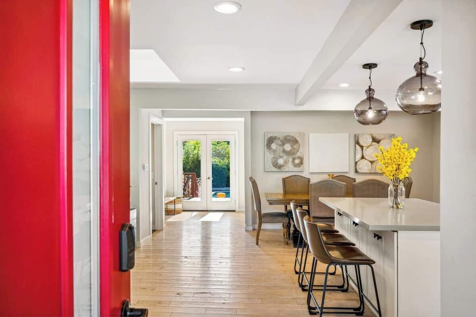 A warm, welcoming entry that opens into a bright kitchen and dining space, offering an easy flow straight out to the sunny backyard.
