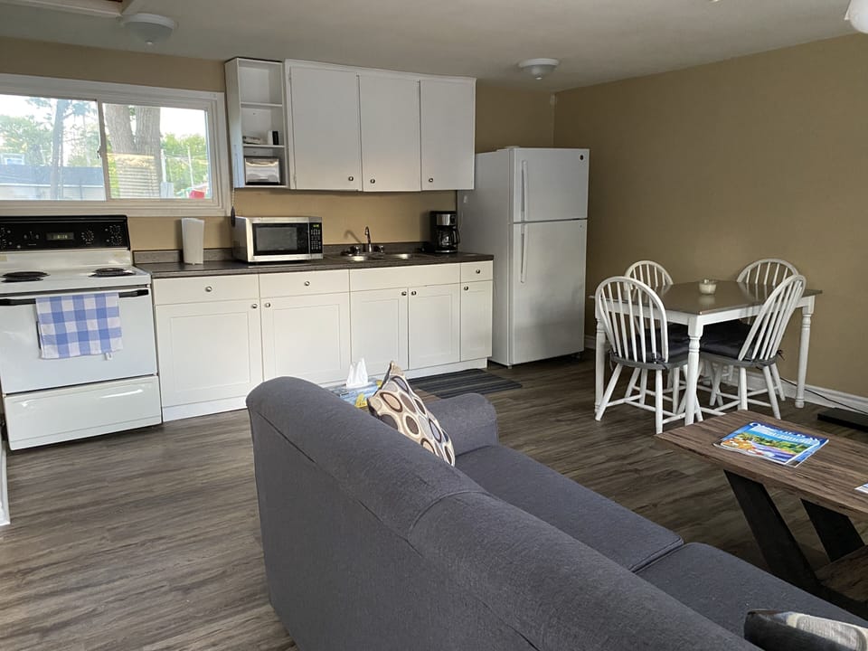 Kitchen includes fridge, stove, microwave, toaster, cutlery, pots & pans, plates
