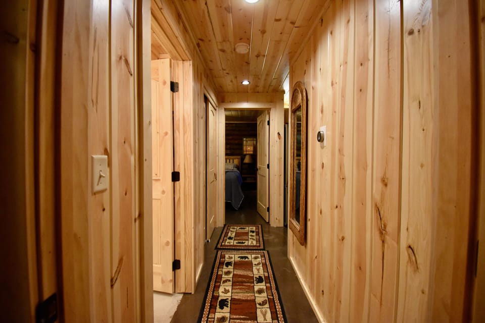Hallway in back of main cabin attaching two bedrooms with bathroom in the middle