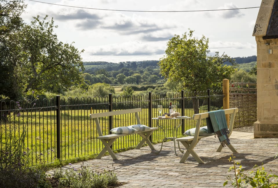 2 south facing patios with views over farmland to Cotswold hills