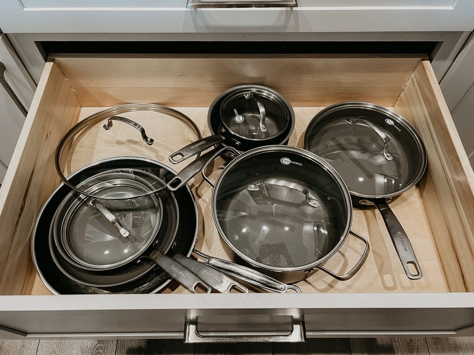 A full set of Greenpan pots and pans, featuring a non-stick ceramic coating.
