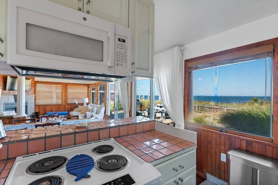 Well-equipped Open Kitchen with new oven and microwave and a bay view.