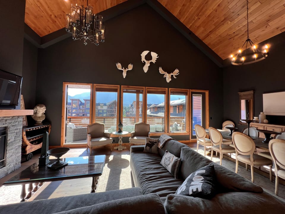 Sunny living room with vaulted ceilings and incredible mountain views