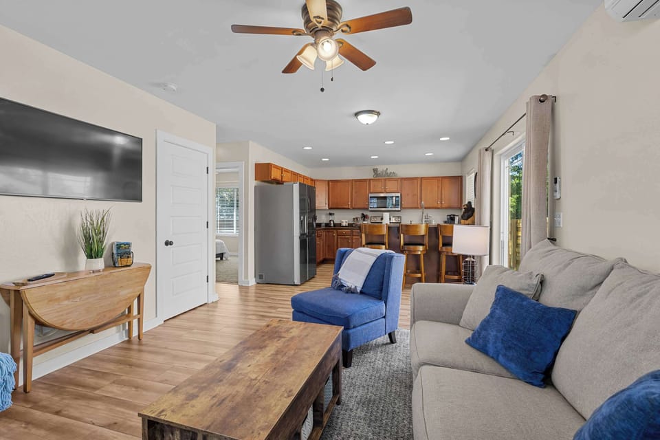 Living area, full kitchen with bar stools and, side access to the patio.