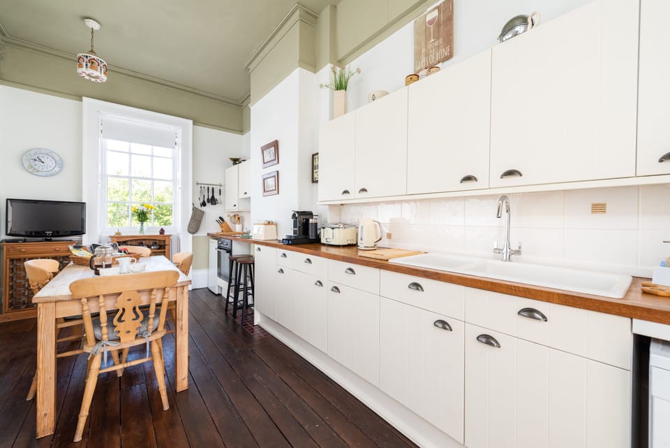 Fully equipped French-style kitchen overlooking the square and courtyard...