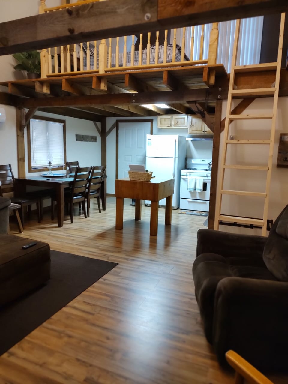 View from living room into kitchen and loft ladder.