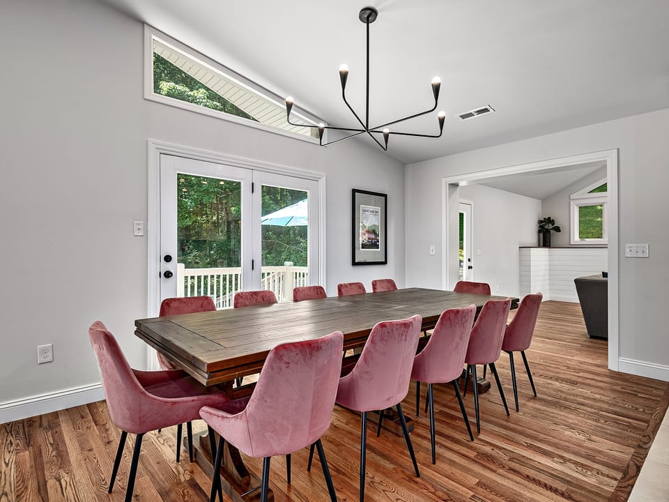 Large Dining Room table with seating for 12 and access to deck