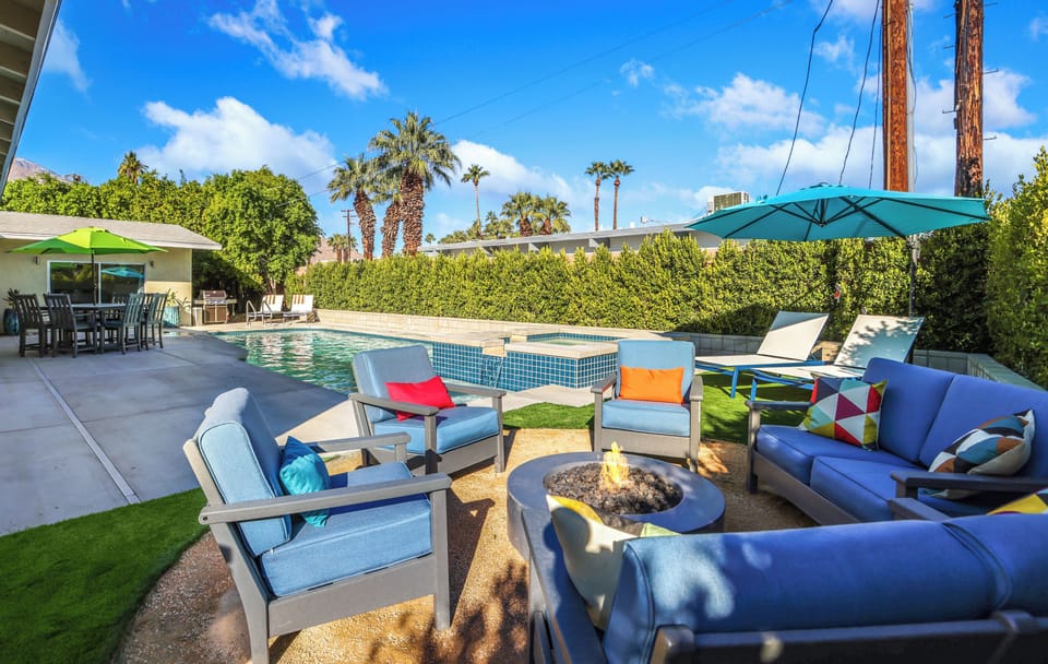 Spacious poolside fire pit area ideal for relaxing evenings