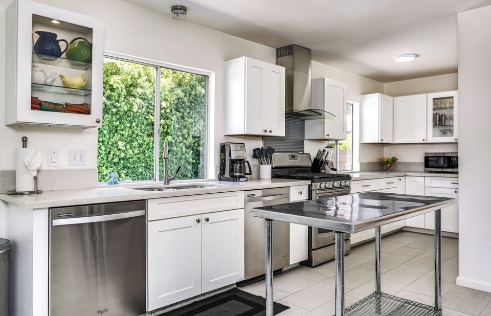 Bright kitchen with gas range, 2 dishwashers, and ample counter space
