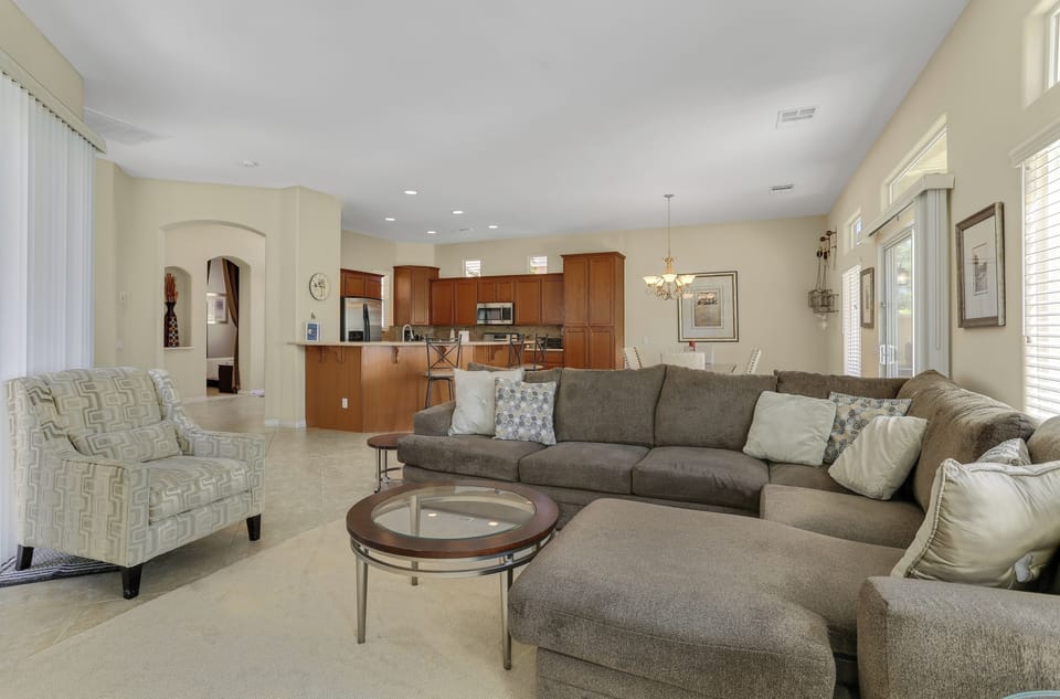 Open-concept living room flowing into kitchen and dining