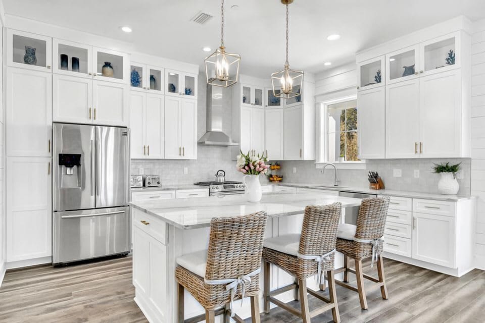 Spacious kitchen w/ island seating, white cabinetry & a clean, modern look.