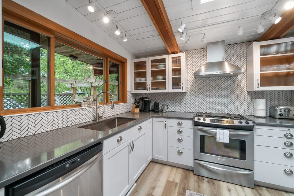 Kitchen with Dishwasher and Gas Stove - updated Herringbone Tile Backsplash